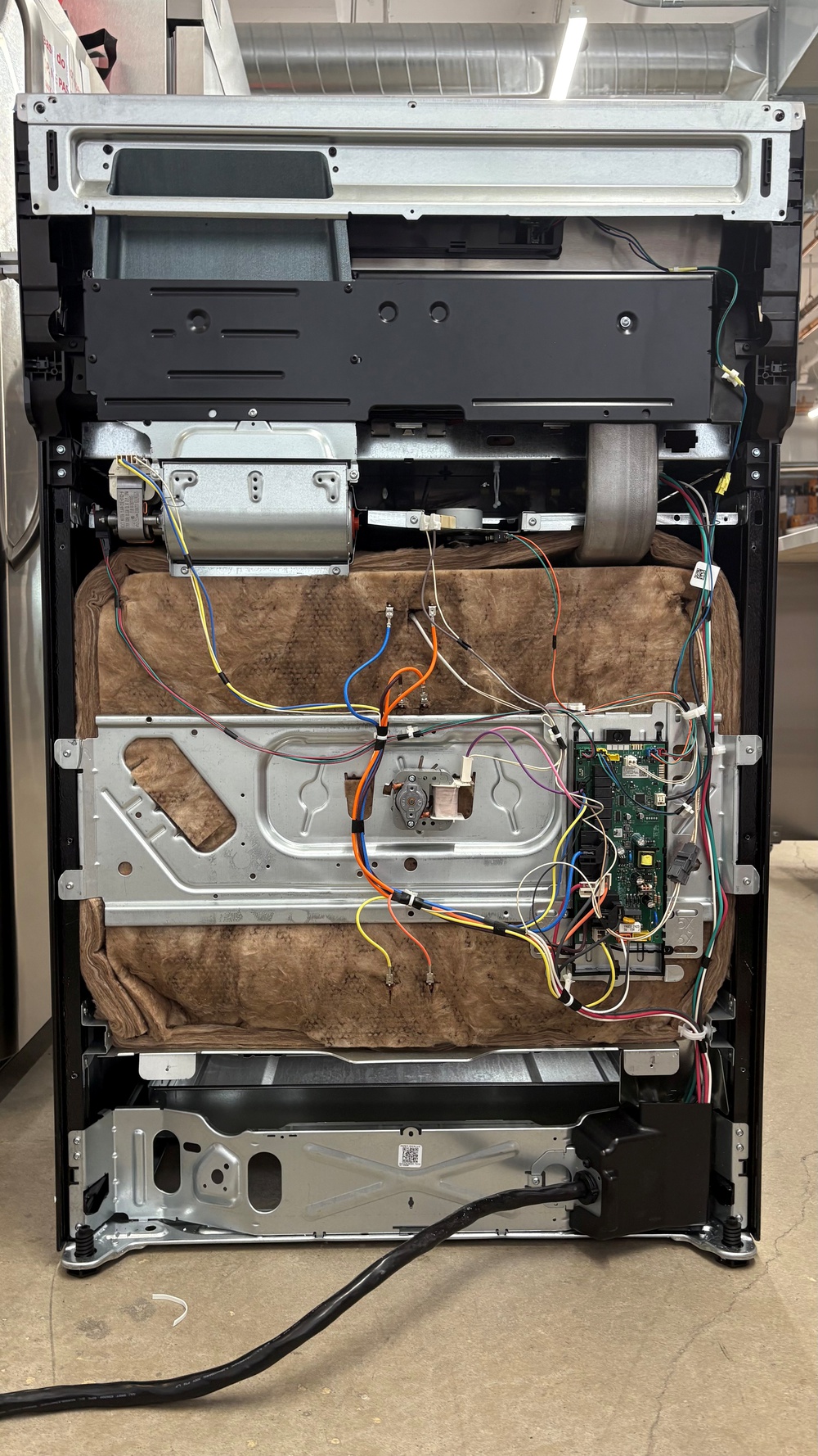 Frigidaire Gallery 30" full-size oven with the rear panel removed, exposing the cooking chamber insulation.