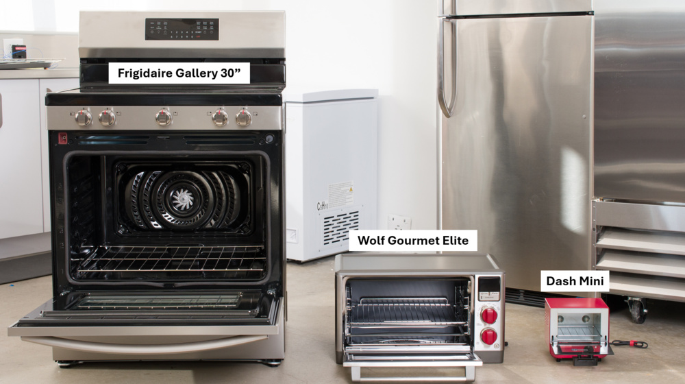 Image of the Frigidaire Gallery 30" next to a large toaster oven, the Wolf Gourmet Elite, and a very small toaster oven, the Dash Mini.