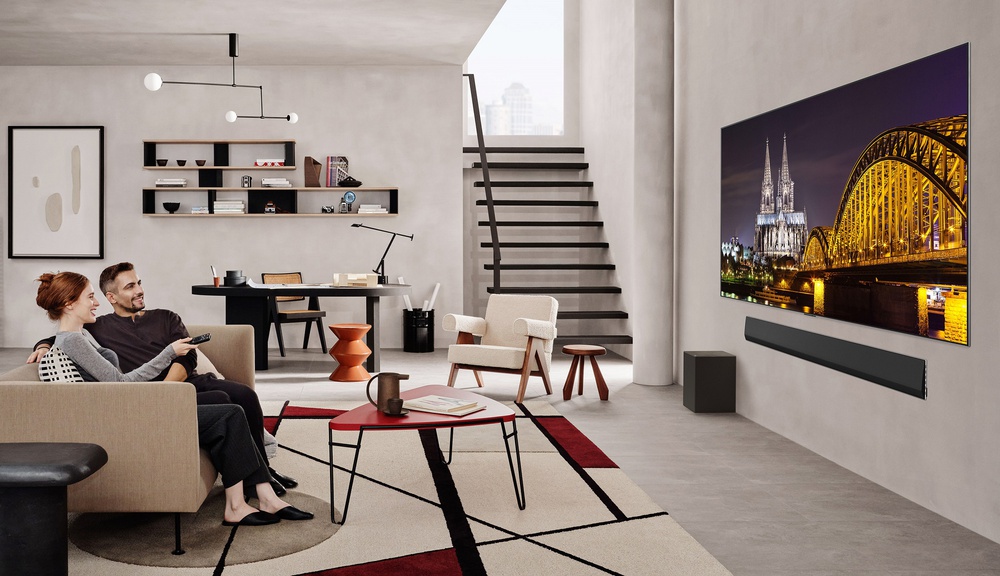 A PR image for the LG G5, showing people sitting on a couch watching the TV.