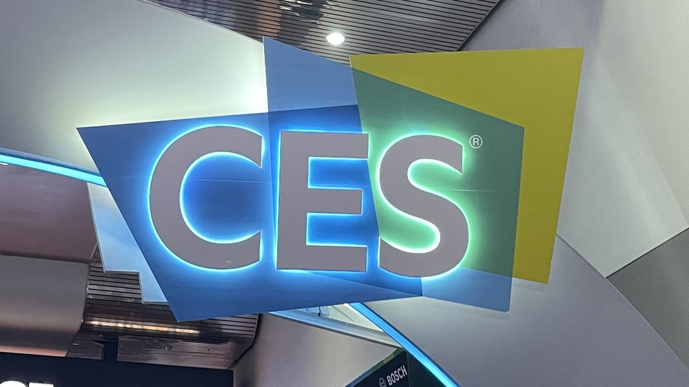 A photo of the CES logo, illuminated from behind.