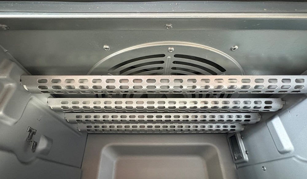 A close-up shot of the fan placement inside the Cuisinart Air Fryer TOA-70, showing the fan above the top four heating elements, facing downward.
