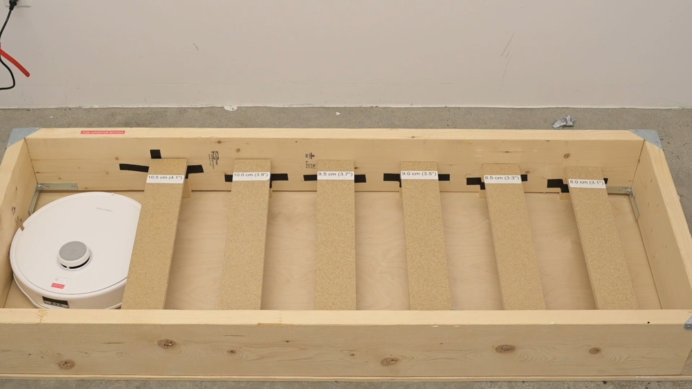 The Roborock Qrevo Curv beginning the threshold clearance test.