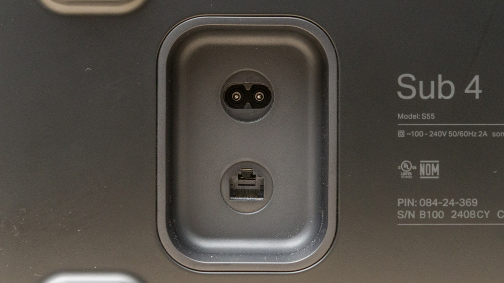 An image of the rear of a subwoofer with a power and ethernet input.
