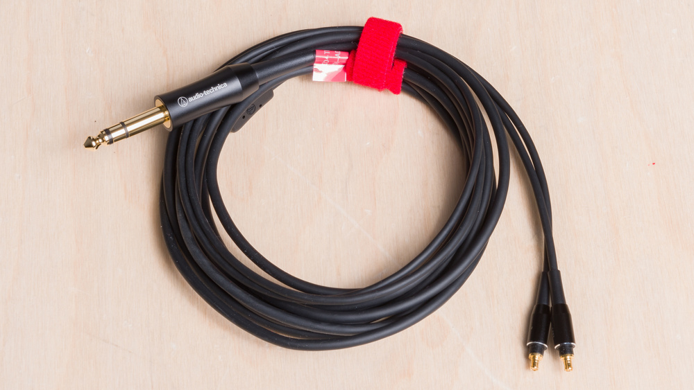 A bird's eye view of a 1/4" analog cable wrapped up.