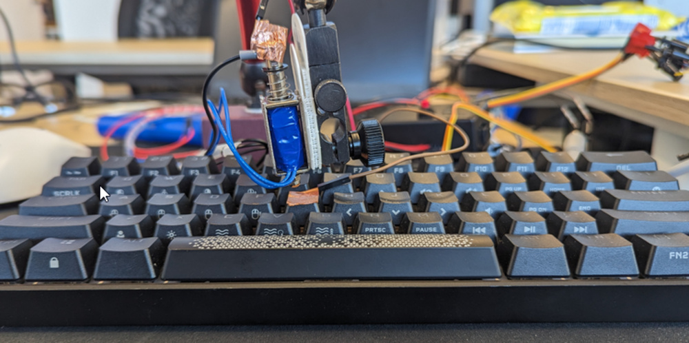 Our standardized latency test rig uses a solenoid that emulates a human finger to perform each sample keystroke.