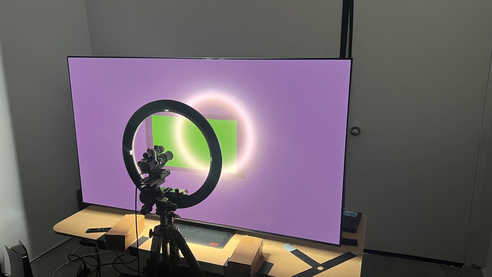 A TV with a ring light pointed at it.